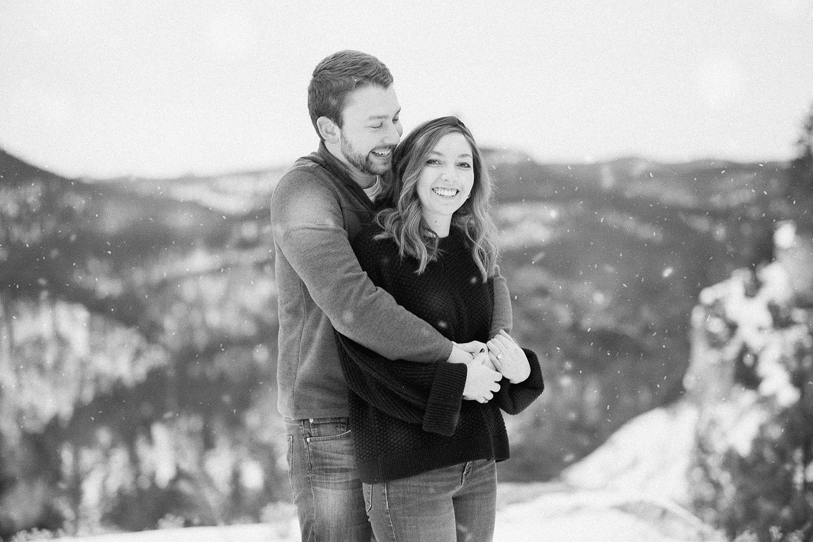 Black and White engagement photograph of couple embracing at Falling Rock near Rapid City, SD