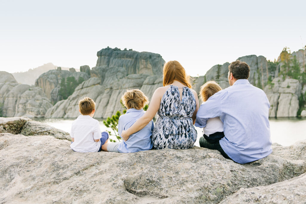 Family sits overlooking Sylvan Lake in Custer State Park, SD