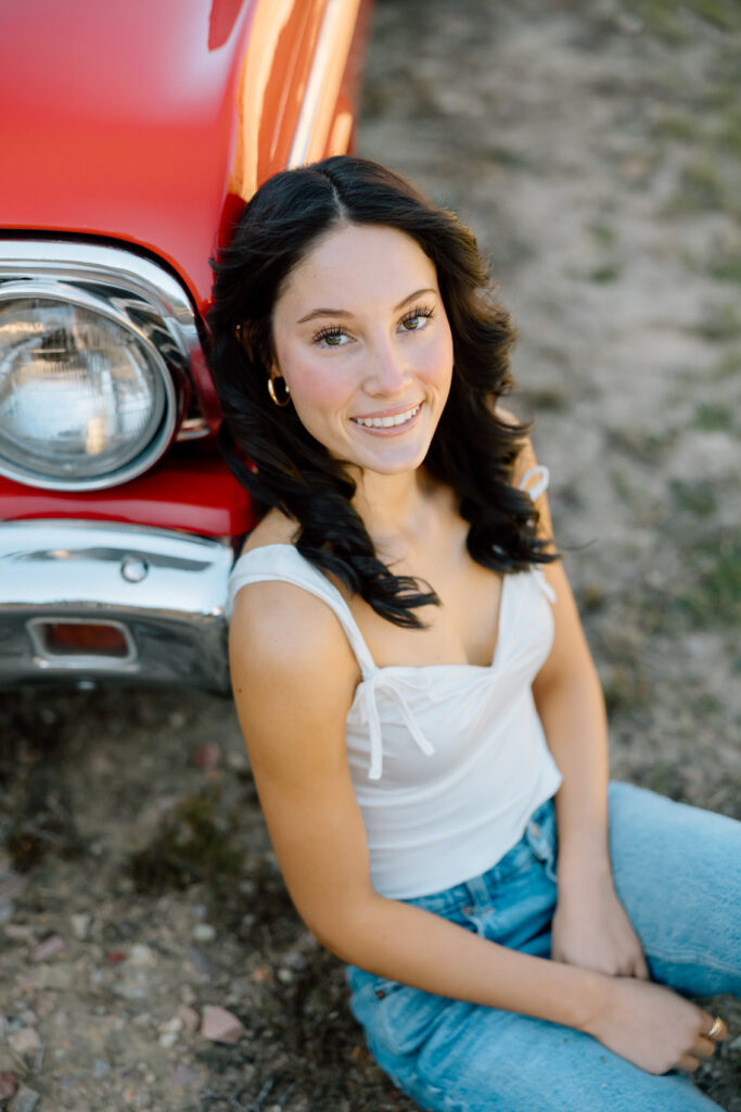 Senior photo of girl next to vintage car